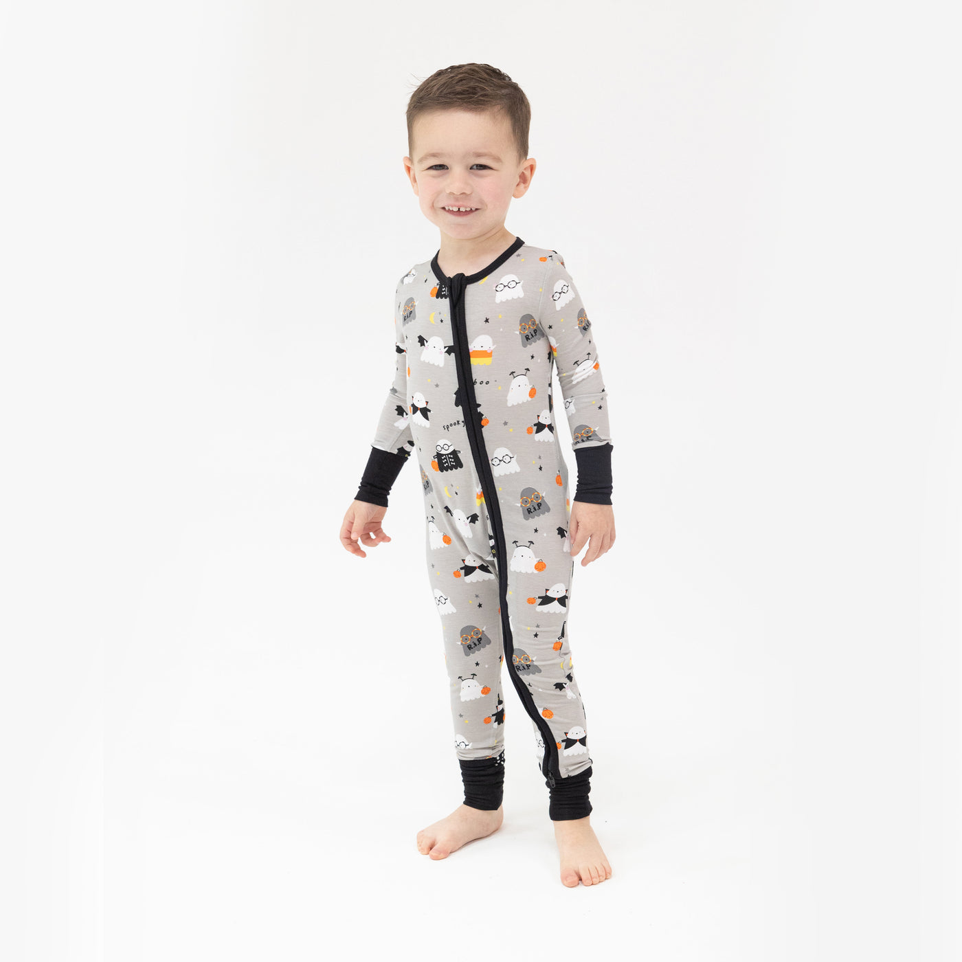 young boy in a costumed ghost zipper lounge wear smiling