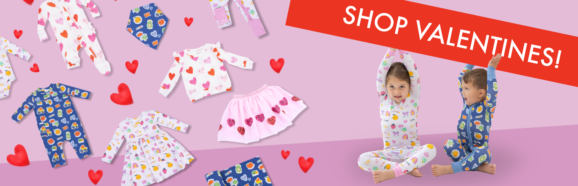 Brother and sister wear Valentines Day printed loungewear while holding up a banner that reads, "SHOP VALENTINES!" Scattered to their side are more pieces from the Valentines day collection.