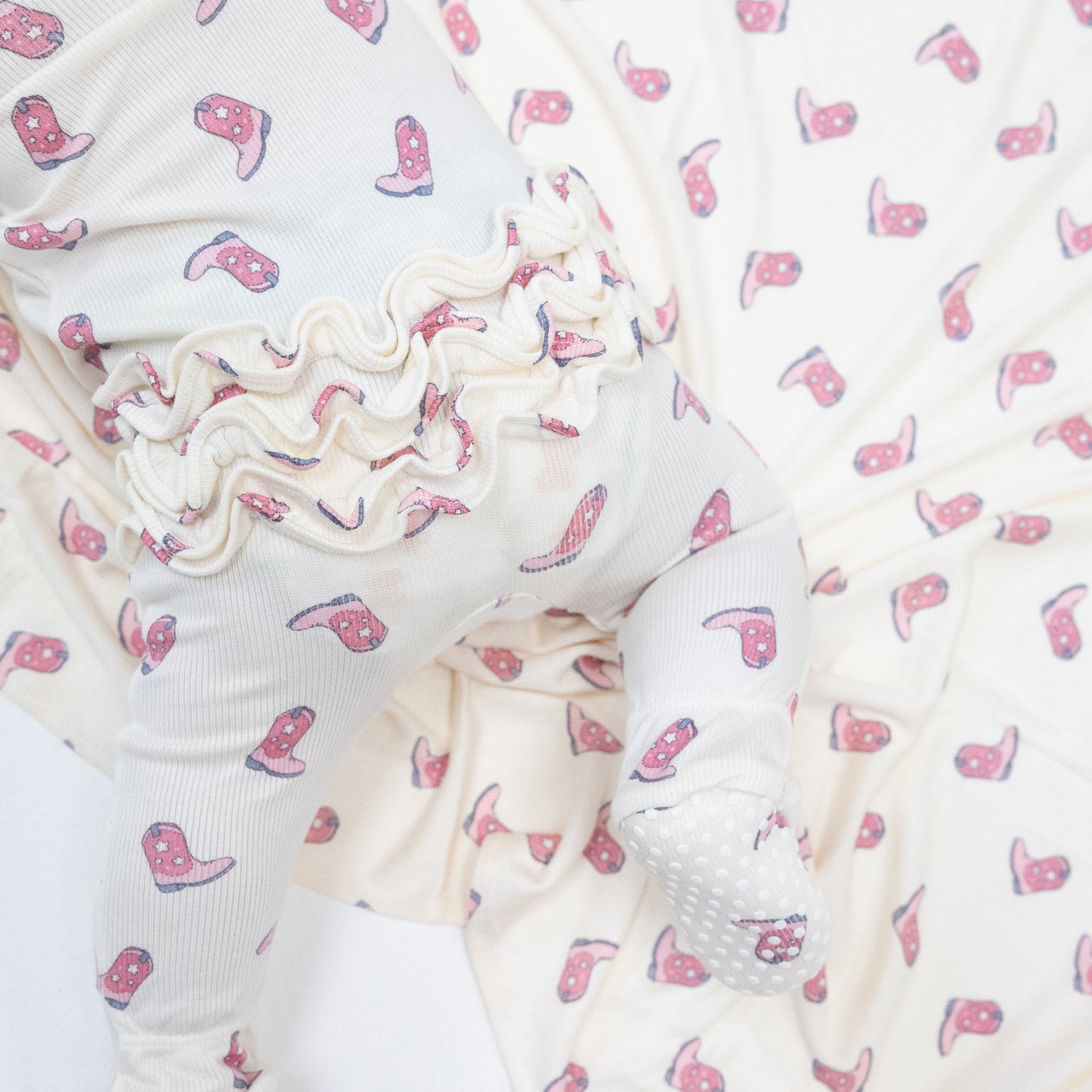 2 Way Zipper Ruffle Back Footie in our  Petite Cowgirl Boots print from Angel Dear