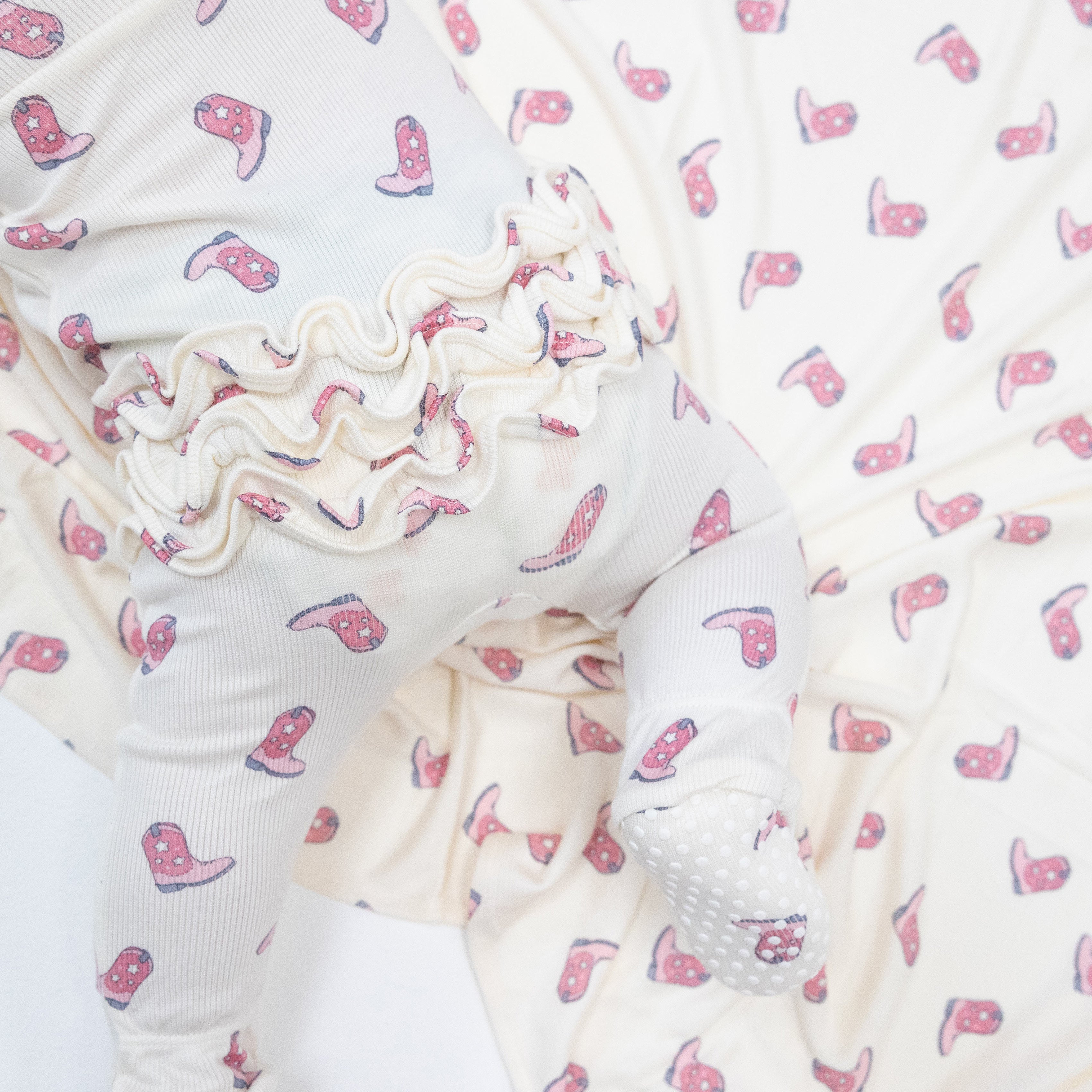 2 Way Zipper Ruffle Back Footie in our  Petite Cowgirl Boots print from Angel Dear