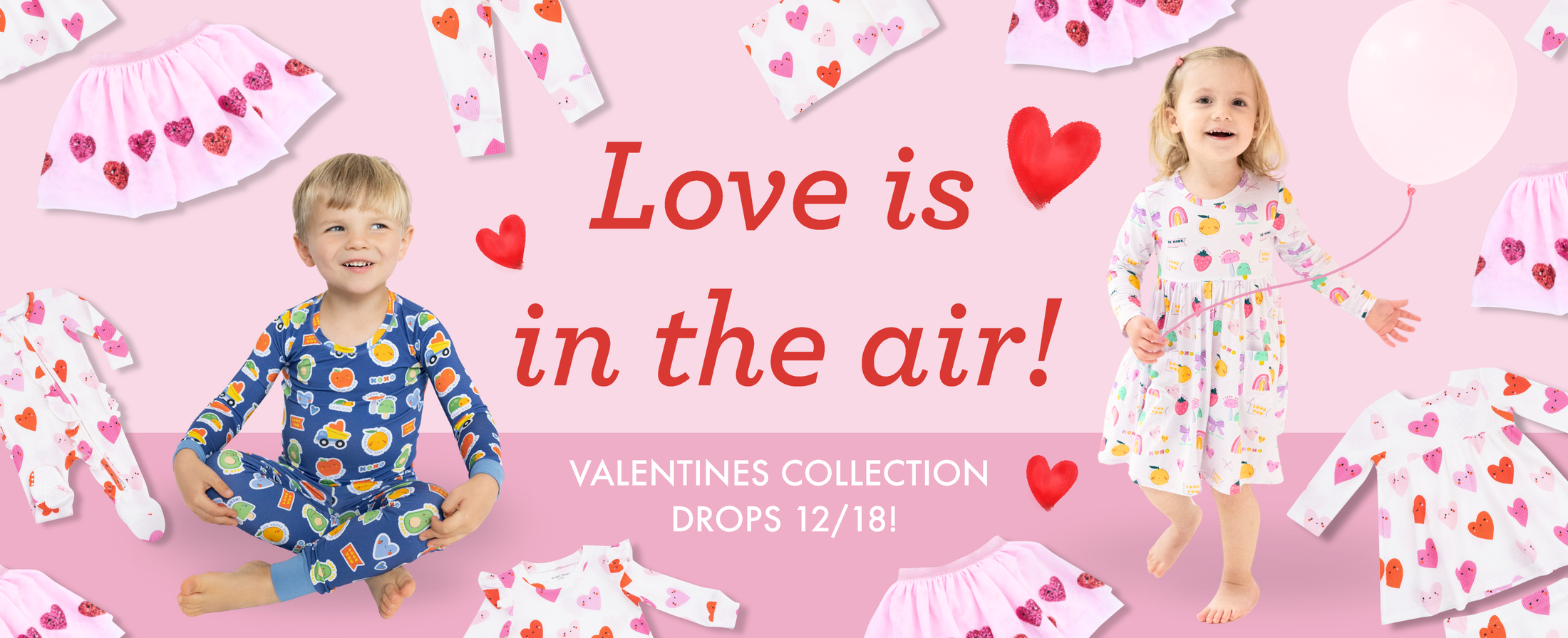 A little boy and girl wear pieces from the Angel Dear Valentine's Day collection. More pieces are scattered n the background. Text reads, "Love is in the air! Valentines collection drops 12/18!"