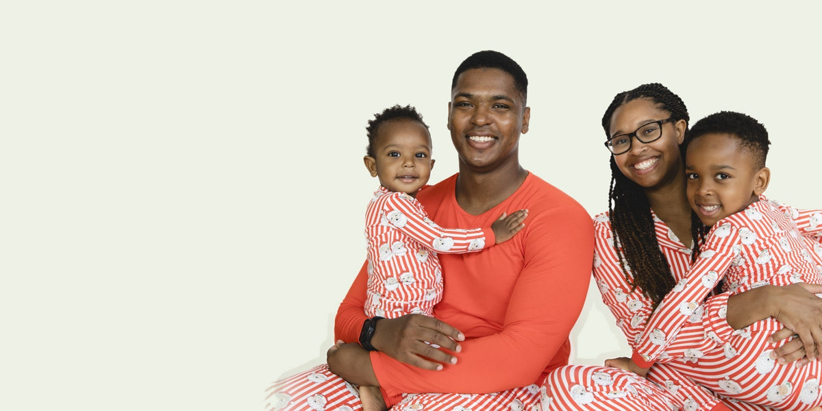 A family matches in the Vintage Striped Santa holiday loungewear in different styles.