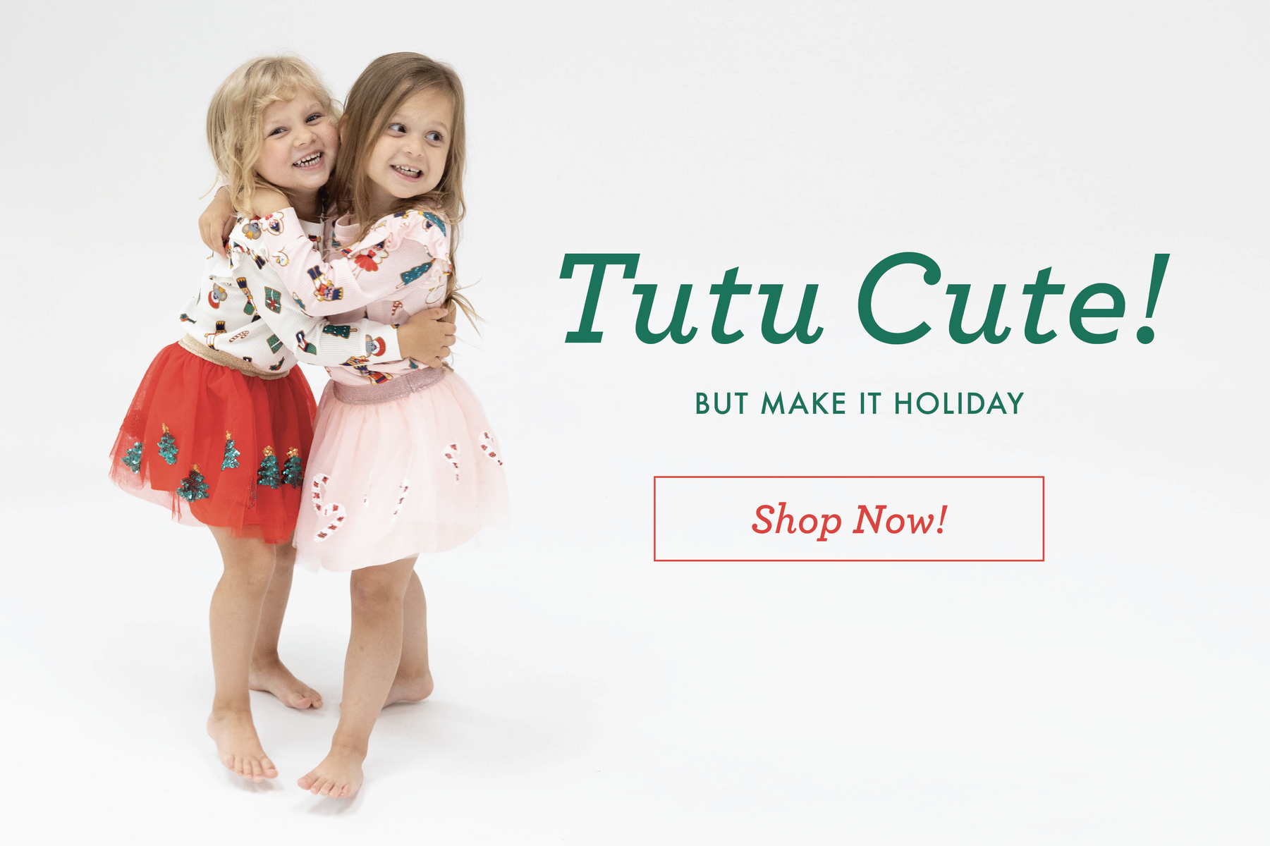 Two little girls hug while wearing Christmas themed Tutu Skirts.