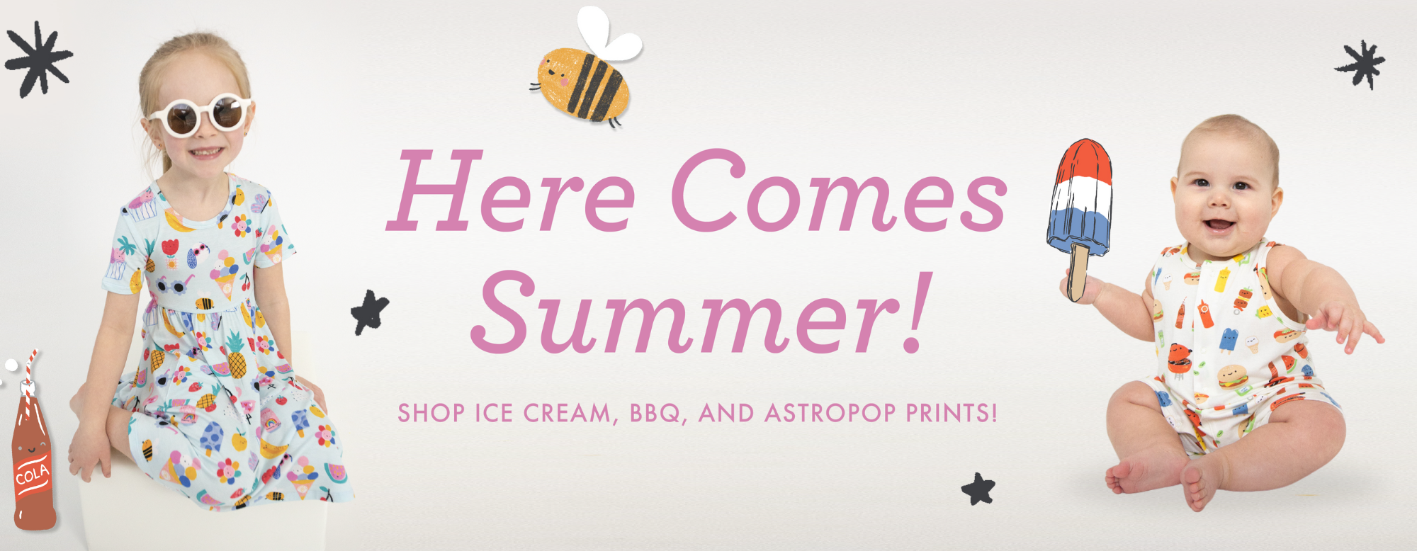 A girl dress in an ice cream summer print with a baby holding an popsicle dressed in summer bbq print - "Here Comes Summer!"