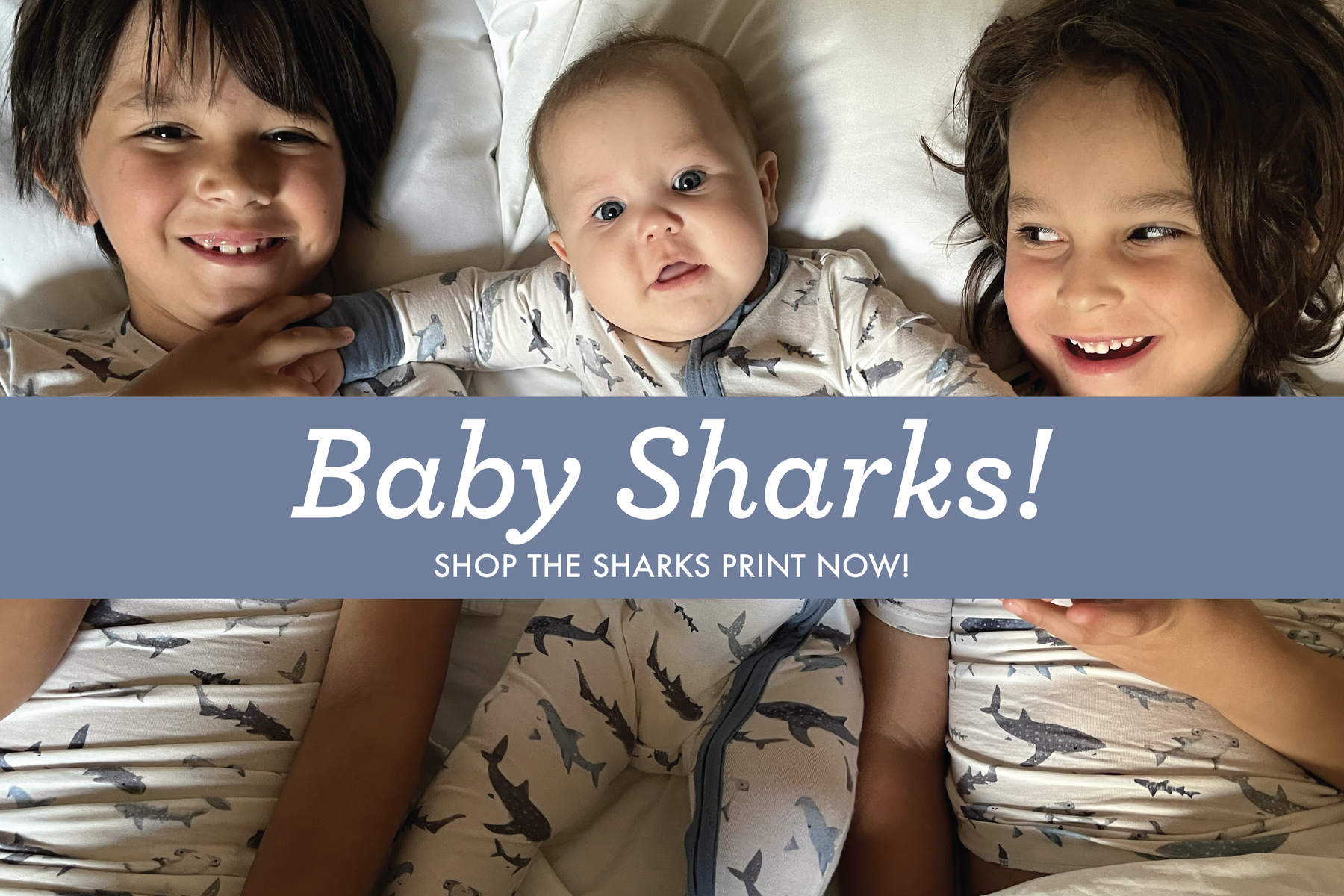 3 young boys smiling wearing baby sharks print