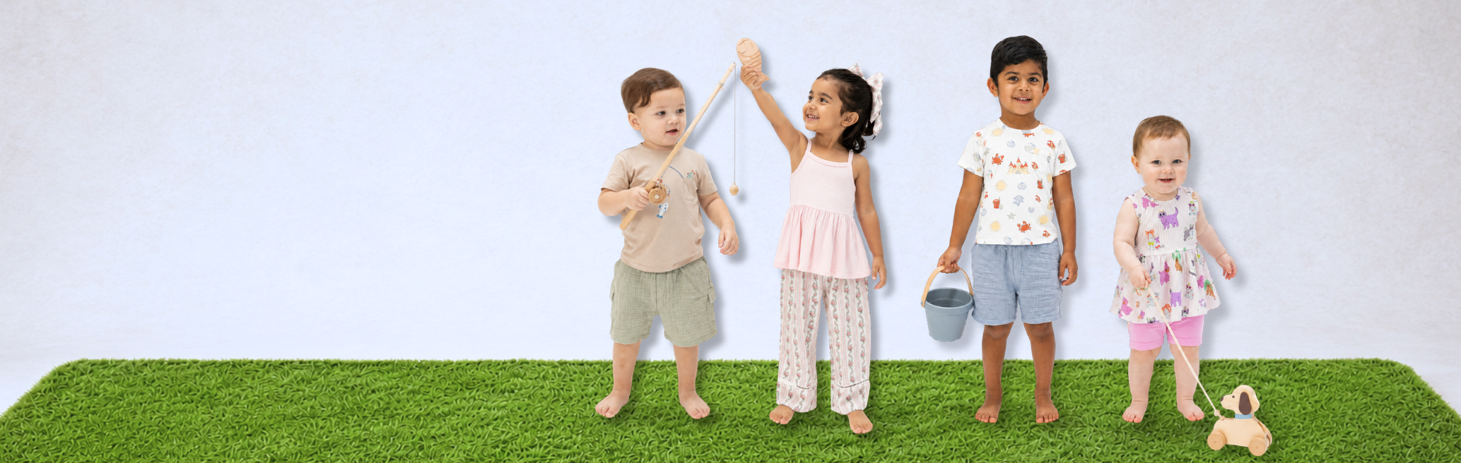Four children standing on a grassy patch with a white background all wearing summer outfits.