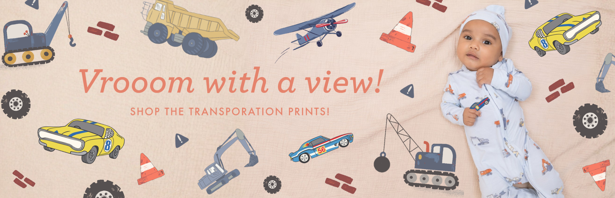 Baby lying on a patterned surface with transportation-themed illustrations and text.