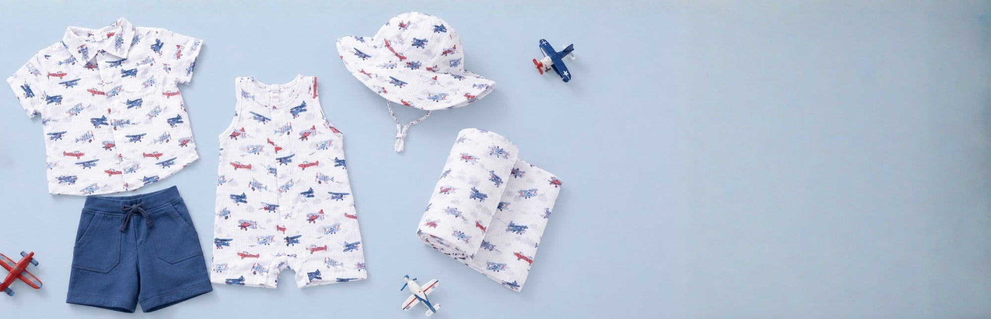 Children's clothing with a vintage airplane pattern on a light blue background