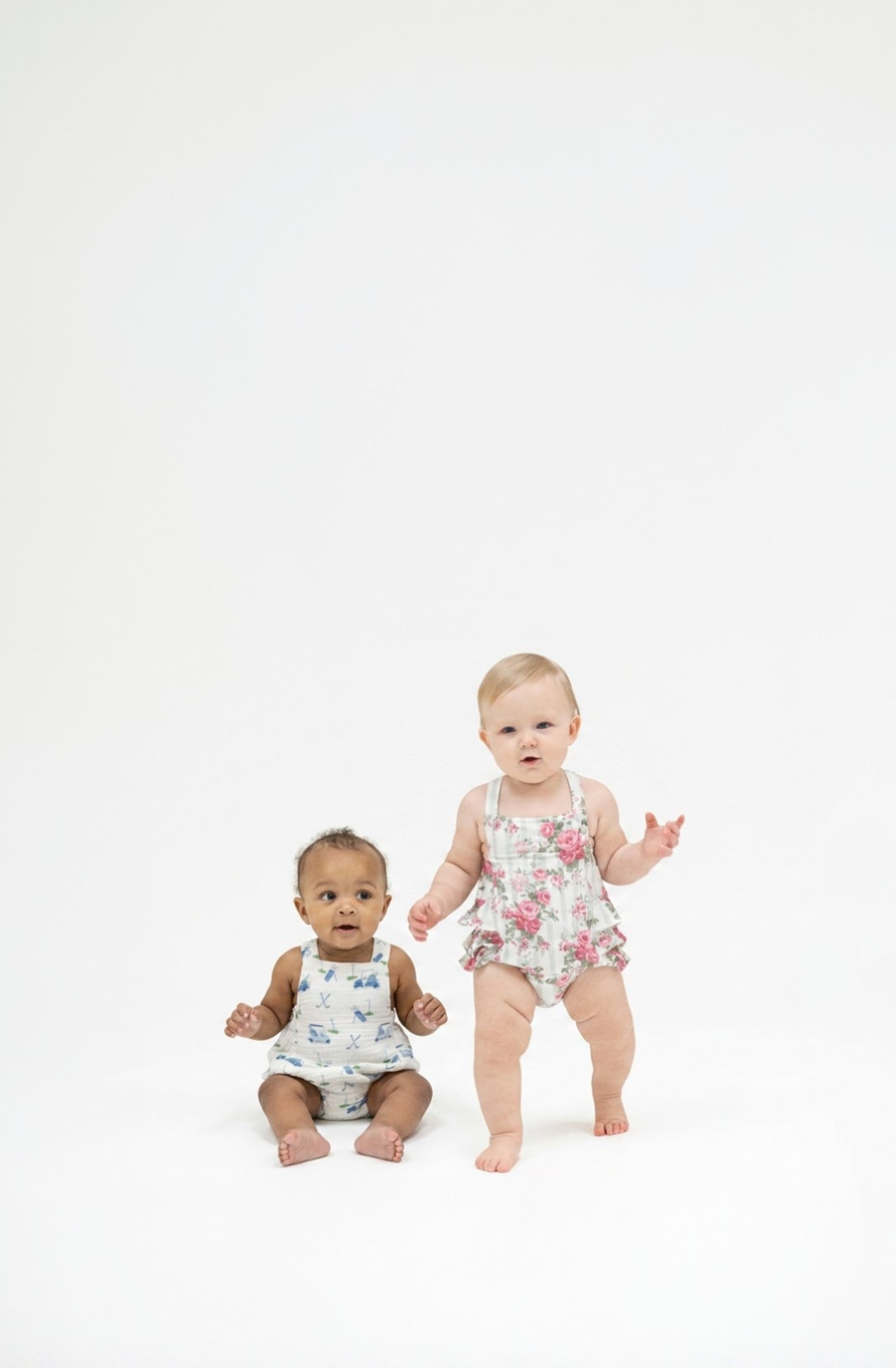 Two toddlers wearing sunsuits.