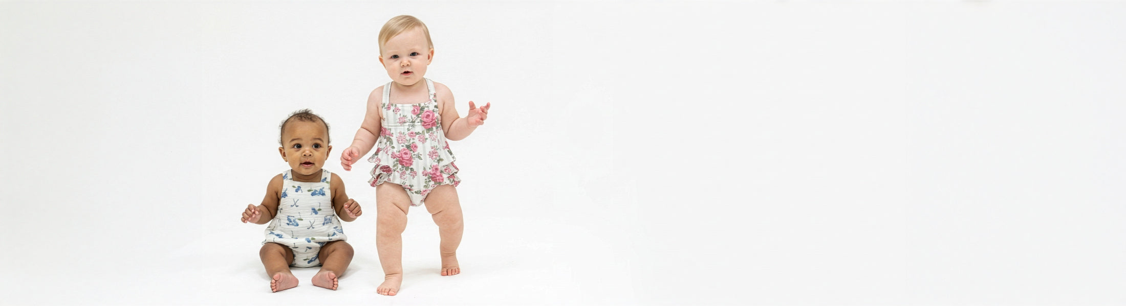 Two toddlers wearing sunsuits.