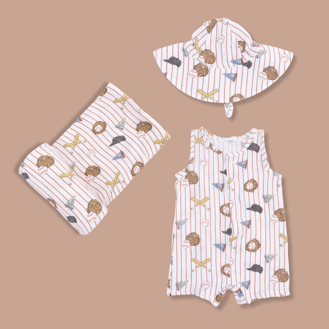 Vintage Baseball Stripe Wide Brim Sunhat, Swaddle and Short Sleeve Romper on Tan Background.