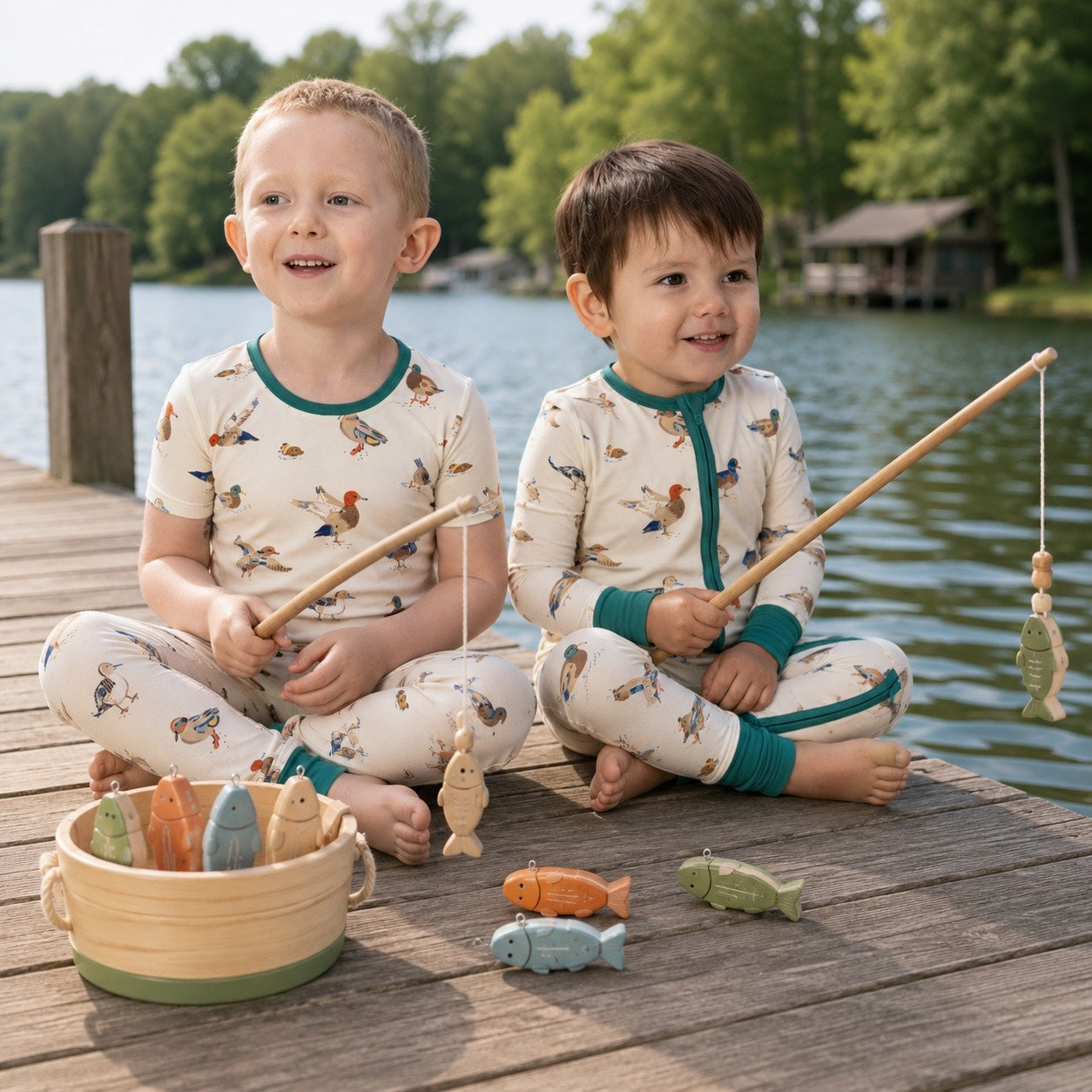 Children playing with fishing toys on a dock by a lake